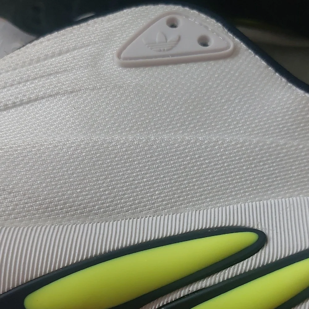 Adidas Adifom SLTN shoes in the Cloud White / SolarYellow / Blue Colorway